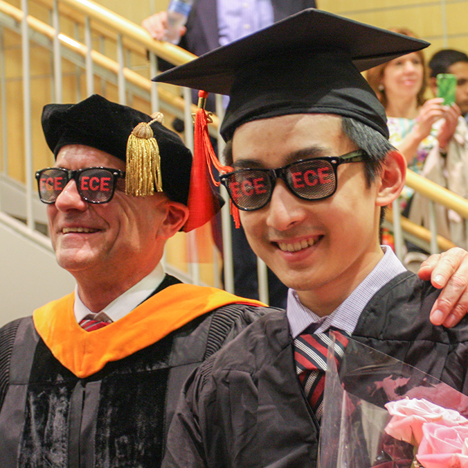 Prof. Joe Skovira and student graduate celebrate together