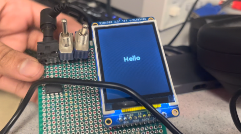 A computer screen says "Hello"